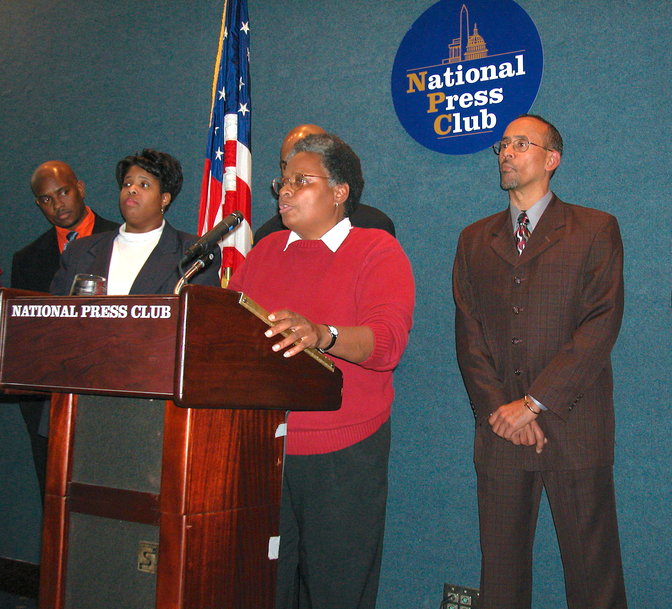 Mandy announcing the National Black Justice Coalition’s support of marriage equality at the NBJC Press event at National Press Club, 2003, Washington, DC. Donna Payne and three men are pictured in the background. Photo courtesy of Mandy Carter.