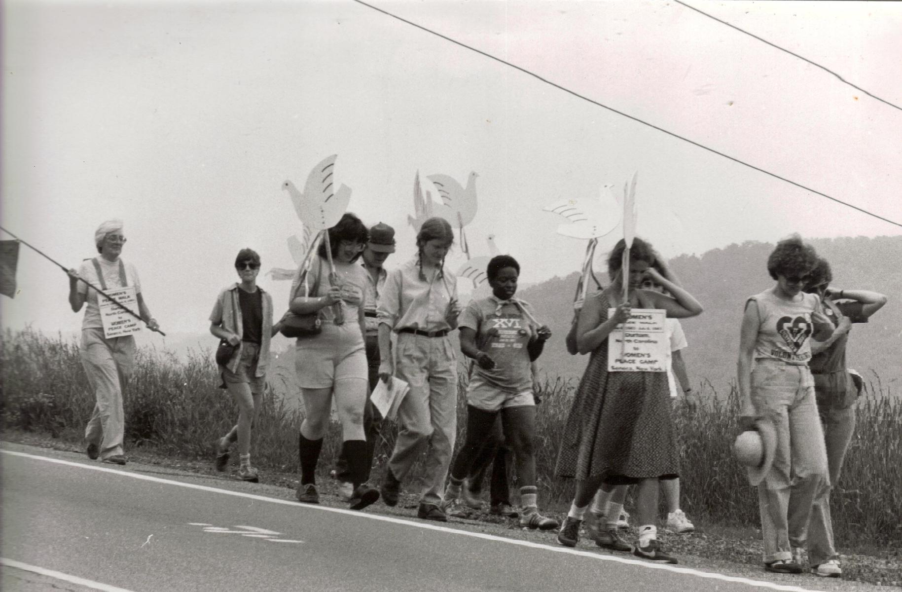 Mandy on the War Resisters League/Southeast Women’s Peace Walk to the Seneca Women’s Peace Encampment, 1983, Seneca, NY. Mandy shares, “I had joined the War Resisters League/Southeast staff in 1982 when I moved from San Francisco to Durham, NC. I was the lead coordinator. This photo was taken by someone on our walk.” Photo courtesy of Mandy Carter.