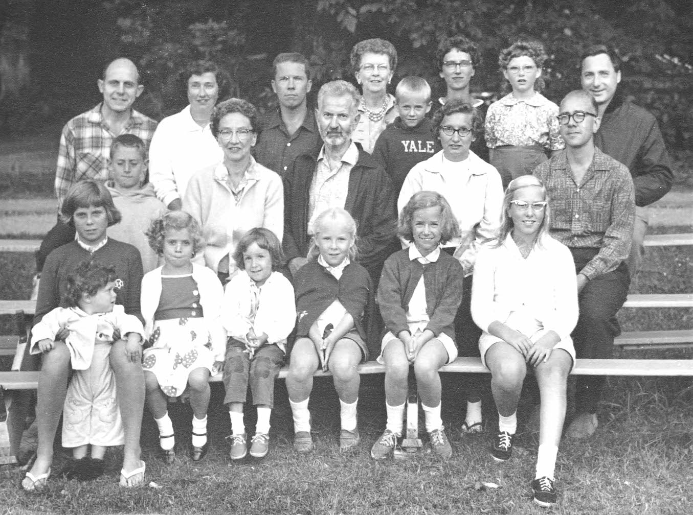 A family portrait of the Churchill Clan in Frankfurt, MI, ~1964-95. This photo features Jennifer’s grandparents, her grandmother’s sister and her son, her mother, and her mother’s sisters, their spouses, and their kids. Jennifer sits in the middle of the bottom row.
