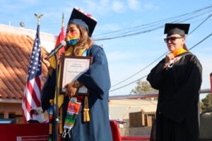 Rosa Diaz on stage with a student speaker to celebrate the 3rd Annual Imperial Valley Lavender Graduation Ceremony for LGBTQIA+ college graduates at the Imperial Valley LGBT Resource Center, Imperial Valley, CA, 2021. She shares, “We honored 15 graduates from different colleges and universities.” Photo courtesy of Rosa Diaz.