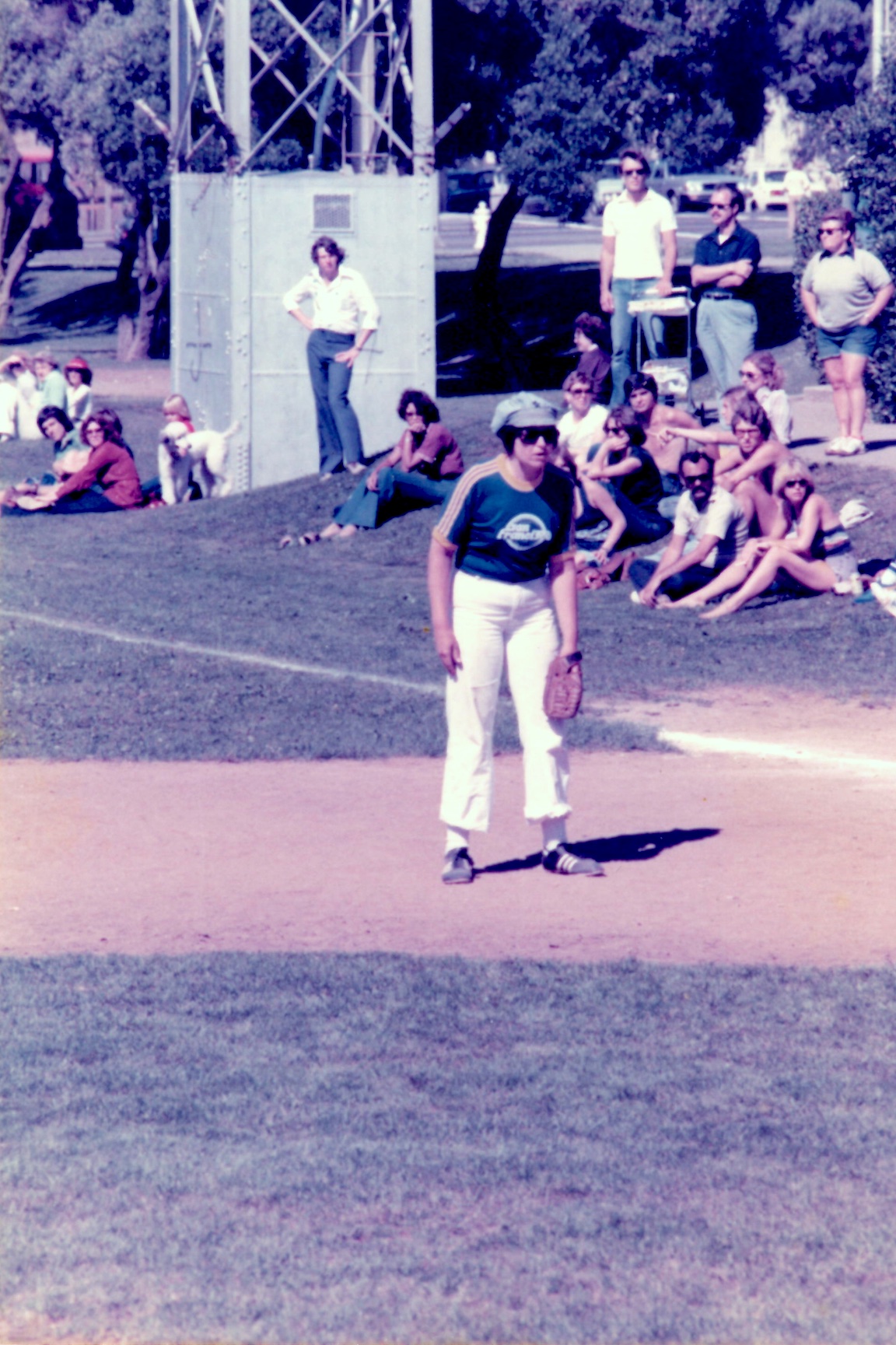 Beth standing at first base, participating in the San Francisco Advertising Softball Women's All    Stars team, 1978, San Francisco, CA. Beth shares, “By now, I realized I had to figure out how to navigate the larger, hetero world with my lesbian community options severely limited. A temp job placed me in the PR Department of the Foote, Cone & Belding/Honig ad agency, where I realized all the things my DOB friends and I had been doing to educate people about lesbianism were professional things for which there were names. I got asked to play softball with the women’s team, and got my first real coaching as an adult woman—and a spot on the San Francisco Women’s Ad League All Star team. It was a coming of age experience.” Photo courtesy of Beth Elliott.