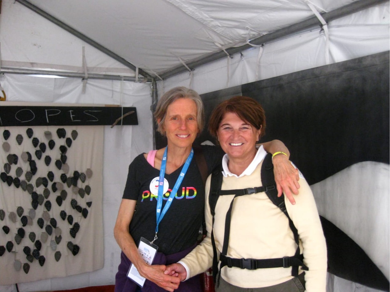 Mary O’Connor and Michela Griffo at the Gay Games in Cleveland and Akron, OH, 2014. Michela shares, “Mary won a gold medal for the U.S.A. in the One Mile Open Water Swim. We are standing in the Peace/Meditation tent which Mary designed for the Games.” Photo courtesy of Michela Griffo.