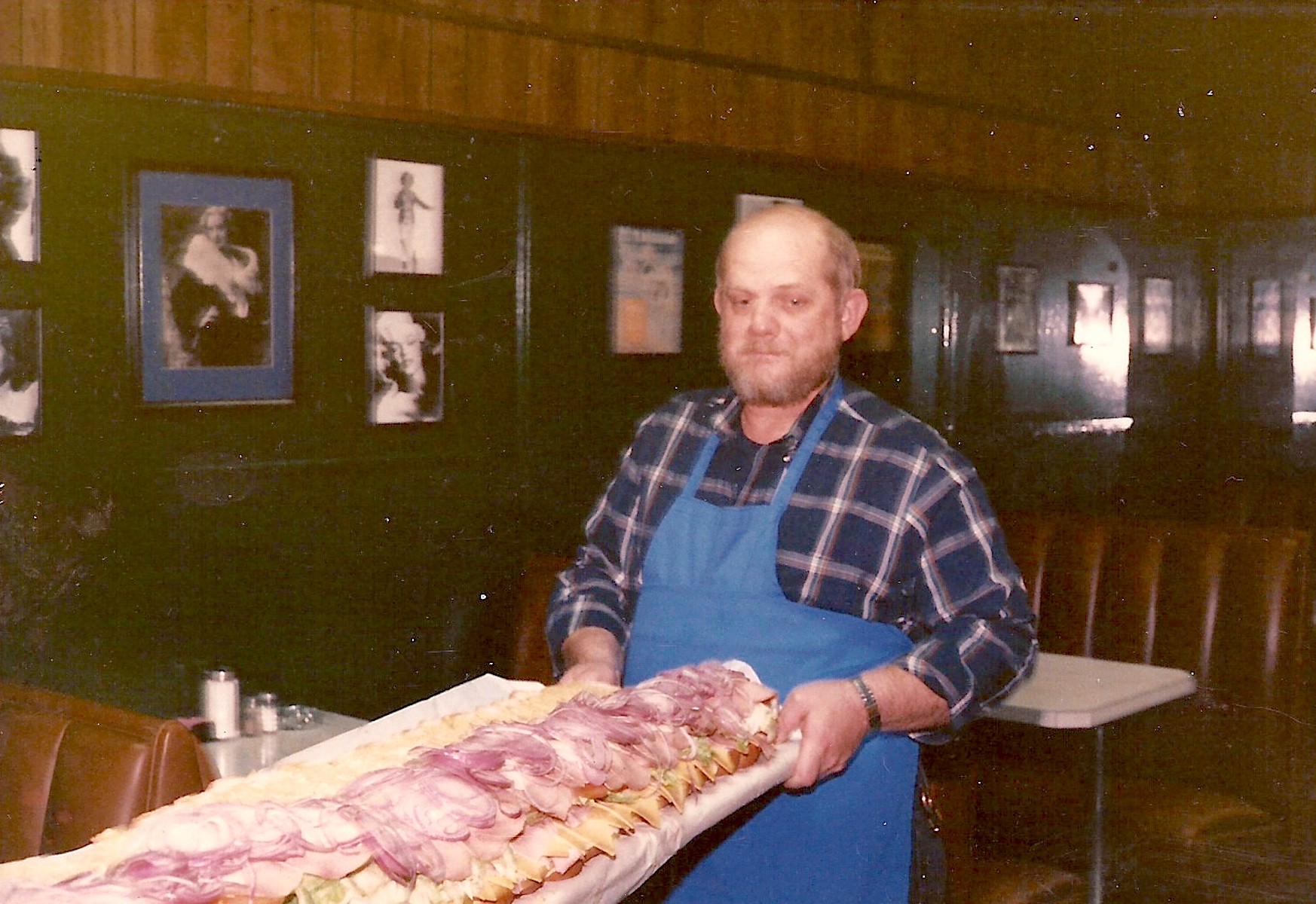 Jack at Peoples Café, holding one of their famous six feet sub sandwiches. Photo courtesy of Jack Myers.