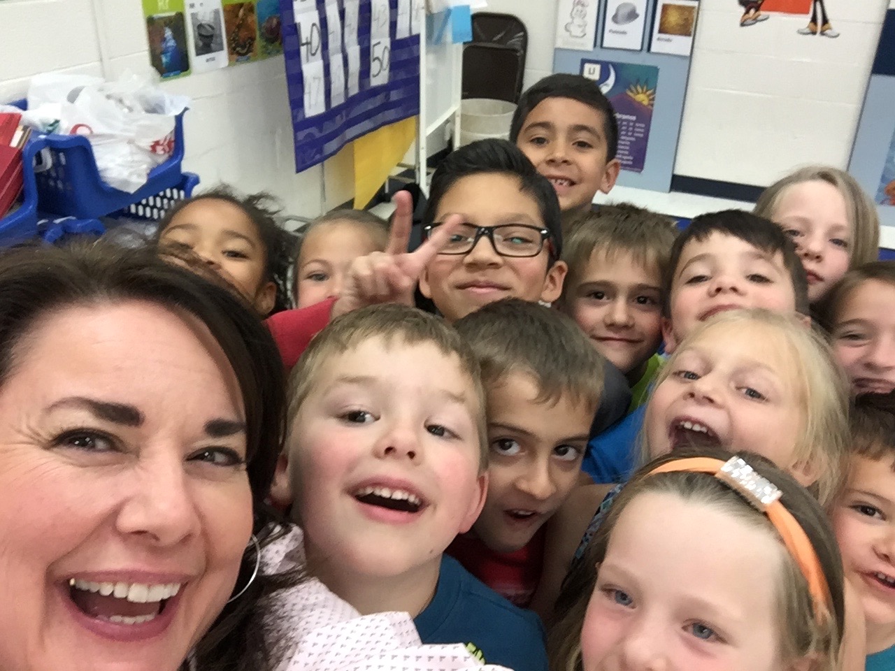 Shanna Peeples with students, Amarillo, TX, Spring 2016. Shanna shares, “This selfie with students was taken right after we read Hansel and Gretel, one of my favorite children’s books. Former students of mine at Palo Duro High School had invited me to come and read to the Camp Fire After School club where they were both working.” Photo courtesy of Shanna Peeples. 