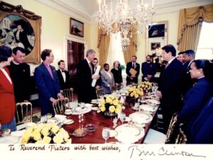 The first AIDS Prayer Breakfast in the Family Dining Room at the White House, November 30, 1993. Steve Pieters stands on President Clinton’s left, with an usher between them holding the President’s chair. Also in this photo, AIDS “Czar,” Kristine Gebbie in red jacket, and Vice President Gore across the table from Clinton.