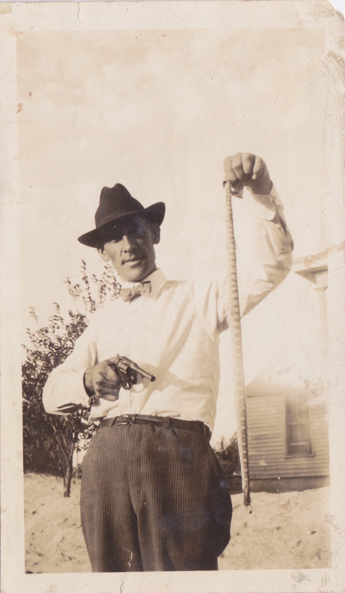 K.C. Potter (grandfather) holding a gun. 