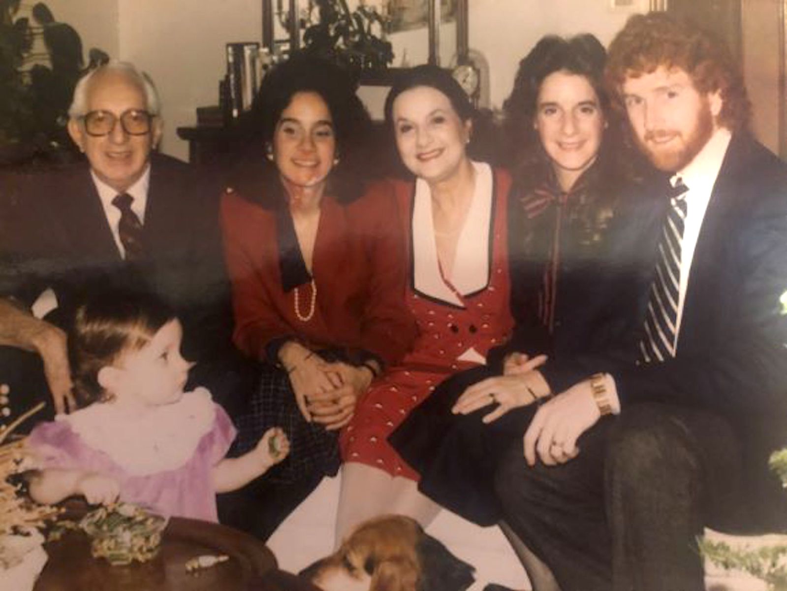 A portrait of the Laham family at Christmas. Cheryl shares, “I just noticed the pearls again! My sister's husband, their dog, and first child were all included here, but my partner was not allowed to come to Kansas.” Photo courtesy of Cheryl Qamar.