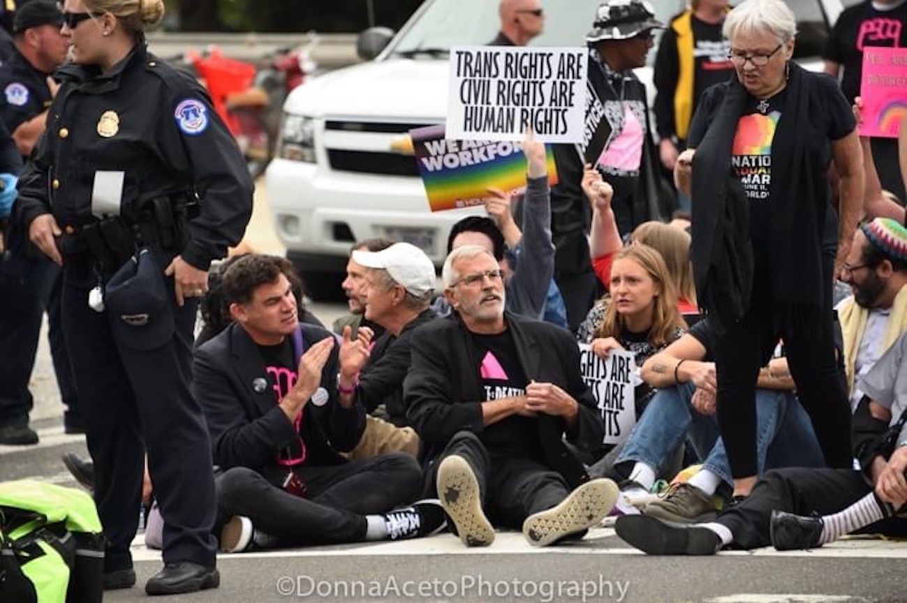 Eric Sawyer and fellow activists protest outside the Supreme Court during Brett Kavanaugh’s confirmation hearing, Washington, DC, 2018. Their signs read “Trans Rights Are Human Rights Are Civil Rights”. Photo courtesy of Eric Sawyer.