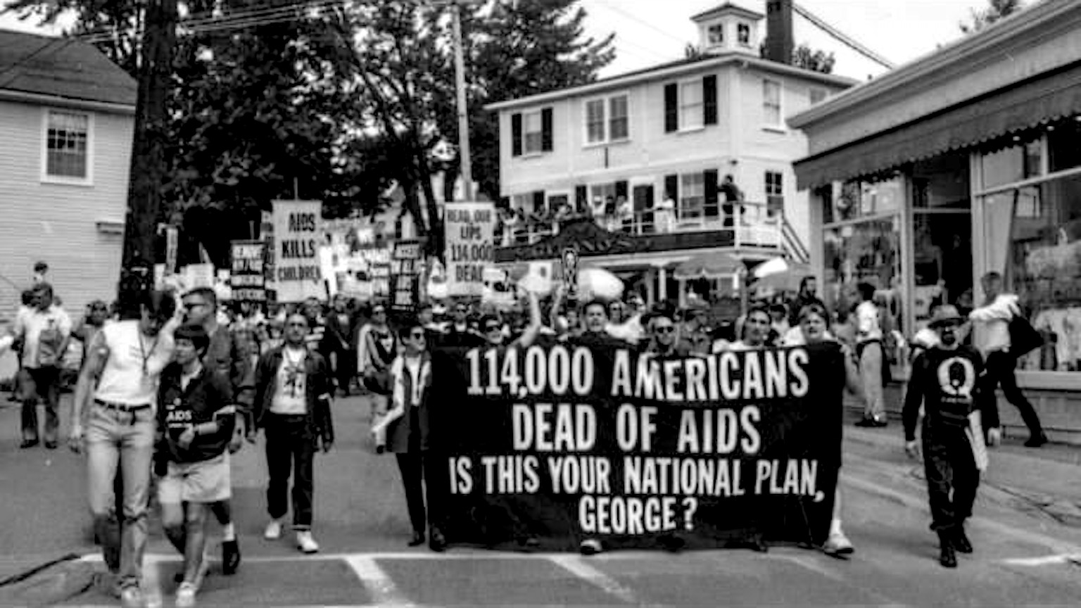 Eric Sawyer and fellow activists protesting against George Bush, Sr.’s inadequate response to the AIDS epidemic, Kennebunkport, ME. Their sign reads 114,000 Americans Dead of Aids. Is This Your National Plan, George?” Photo courtesy of Eric Sawyer.