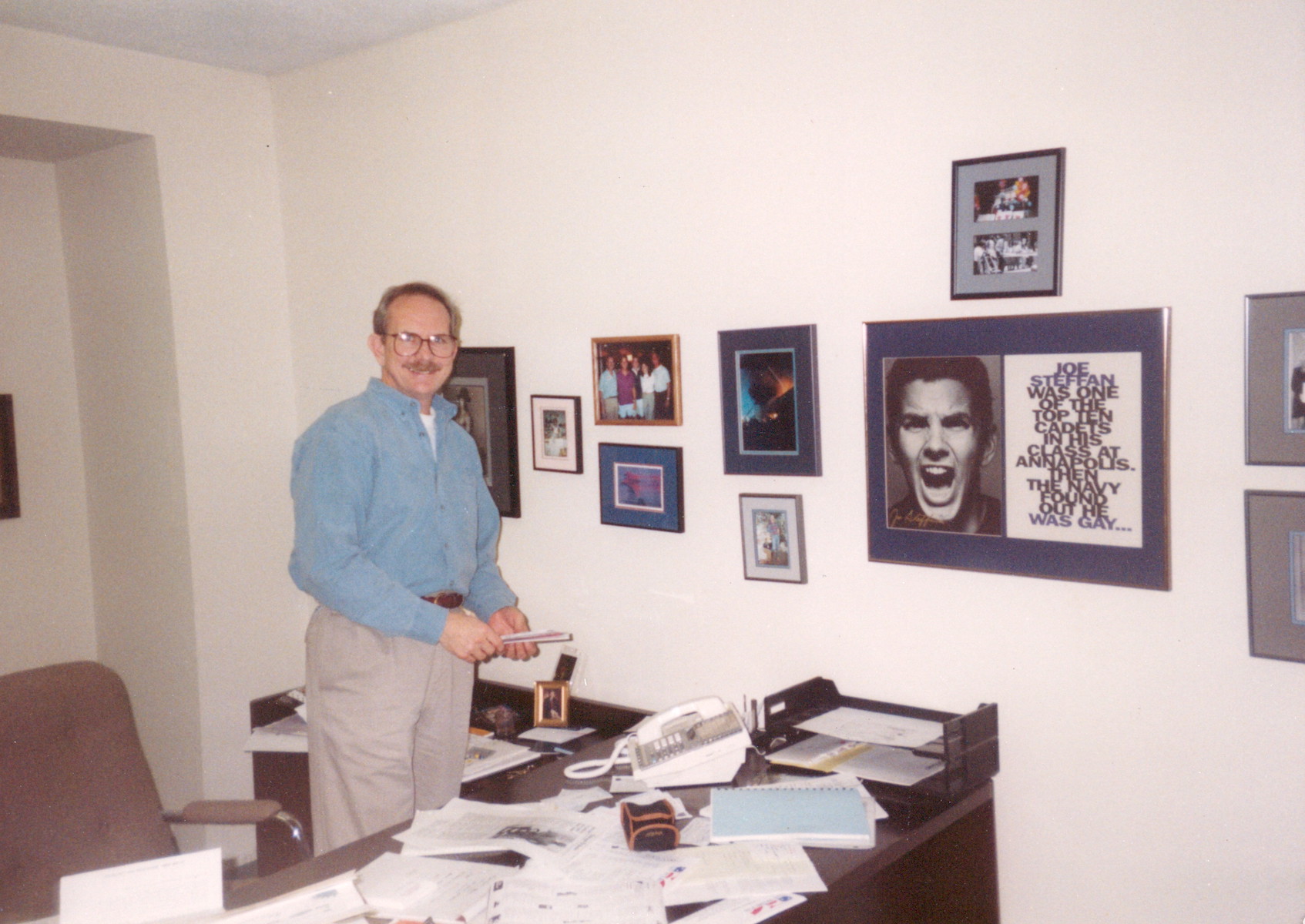 William standing next to his wall of LGBTQ heroes in his Victory Fund office, Washington, DC, circa 1994. Photo courtesy of William Waybourn.