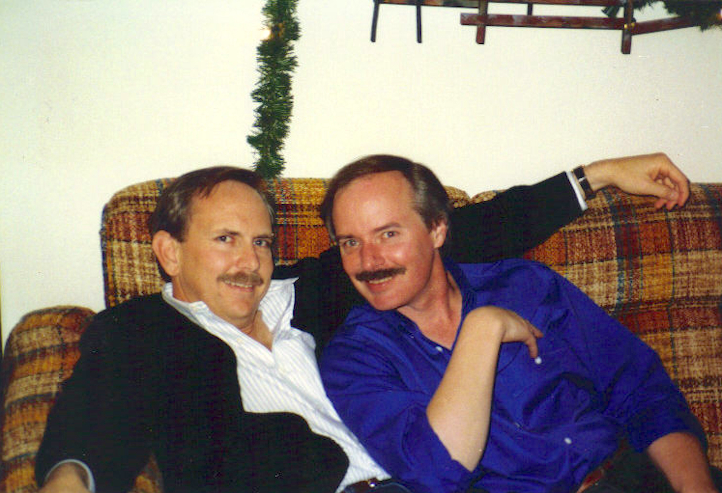William Waybourn and his partner Craig Spaulding on a sofa at Linda Mitchell’s house watching the evening news, Dallas, TX, circa 1988. William shares, “Linda taped every news program on her VCR and later donated all the clips to The Dallas Way history project.” Photo courtesy of William Waybourn.
