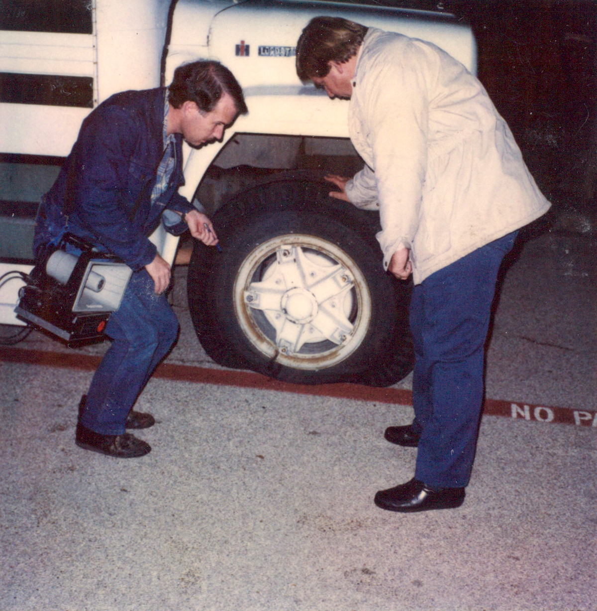 Unidentified Christians inspecting their flat tires in Dallas, TX, circa 1982. William shares, “A fundamentalist church would send its followers to the “Gay Crossroads” Cedar Springs area on weekends to “minister” to LGBTQ people on the street, who were coming out of our store or local bars. The “preachers” were rude and obnoxious, so one night several of us found their bus parked several blocks away and removed the valve stems from their tires.” Photo courtesy of William Waybourn.
