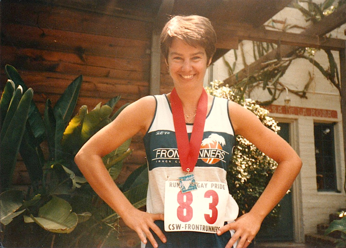 Amy Ross running in the first “Run for Gay Pride”, 1983, Los Angeles, CA. She shares, “I joined the Los Angeles Frontrunners in 1983. Frontrunners is a collection of LGBTQ running clubs worldwide. We derived our name from the Patricia Nell Warren novel The Frontrunner. Over the years, I served on the Frontrunners Board and as Vice President and President.”