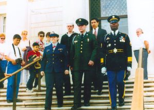 L-R: Virginia Adams (lesbian Navy veteran), George Dunbar (Navy veteran), Cliff Arnesen, Aldo Rodriquez (gay army veteran), and Tomb of the Unknown Sentry step off to lay a wreath at the Tomb of the Unknown Soldier, representing the New England Gay, Lesbian and Bisexual Veterans at Arlington National Cemetery in Arlington County, VA, on May 5, 1993.