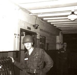 U.S. Army Pvt. Clifton Francis Arnesen, Jr, (age 17) at rifle rack in barracks during Basic Training at Fort Dix, New Jersey, 1965.
