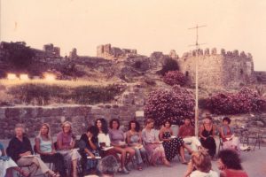 Corky Wick (2nd from right) at the Aegean Women’s Study Institute poetry reading, Summer 1981, Lesbos, Greece.