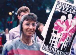 Corky Wick’s girlfriend Annie Bailey carries a Mothertongue poster at Gay Freedom Parade, 1982, San Francisco, CA. Corky helped start the Mothertongue Feminist Theater Collective in 1976. 