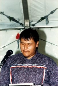 Crisosto Apache performs at a Native-American-focused poetry reading. Crisosto received a summer scholarship in 1991 to the Naropa University in Boulder, CO.