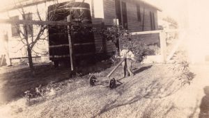 A 4-year-old Charles Little pushes an old lawn mower, Jefferson Parish, Fulton, LA.