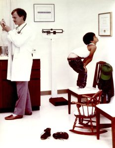 David featured with a patient in a newspaper ad campaign for his employer, 1988. This photo is a Norman Rockwell reproduction. Photo courtesy of David McEwan.