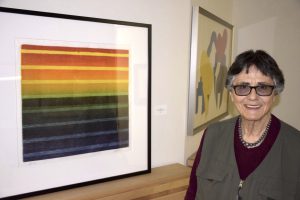 Diane Divelbess in front of a rainbow painting, June 17, 2017.