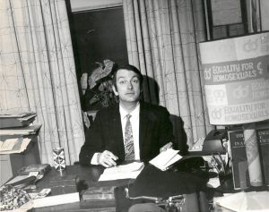 Dick Leitsch at his desk when he was the president of Mattachine NYC in the office located at 1133 Broadway, New York, NY. The poster beside him, “Equality for Homosexuals”, were produced as bumper stickers initially. Nobody was willing to put them on their car for fear of retaliation so they ended up dispersing them all over the village to get rid of them.