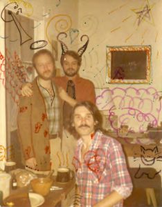 Franklin Abbott standing next Neil Adams, his lover at the time, and Raven Wolfdancer sitting in front, an artist and another member of the Gay Spirit Visions Conference, Iverson Street house, 1979, Atlanta, GA. Doodling on the photo was likely done by Raven Wolfdancer.