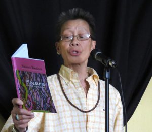 Kitty reading from “Sinister Wisdom,” at the Take Four Café, Oakland, 2014. Photo credit: Cathy Cade. Photo courtesy of Kitty Tsui.