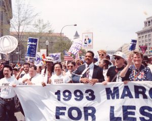 Kitty Tsui marching on the frontline with AIDS and POC activists, and others including Colonel Margarethe Cammermeyer, Cybil Shepherd, Harry Hayes, Cleve Jones, and Jewelle Gomez at the 1993 March on Washington for Lesbian, Gay, and Bi Equal Rights and Liberation, Washington, D.C. 1993. Kitty shares, “The Reverend Jesse Jackson barged (yes, literally!) into the frontline when we marched by the White House where he and his bodyguards had been waiting. (So, no, he had not been marching with us. It was a photo op.)”