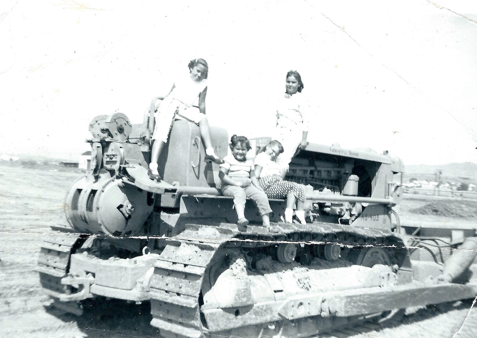 Lani with her sisters Vickie, Bobby, and Kathy sitting on their dad’s tractor, 1955.
