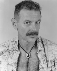 Author photo featuring Perry Brass in a bolo tie, 1995. Photo Credit: Anthony Colantonio. Photo courtesy of Perry Brass.