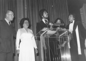 Richard presenting award to the parents of Freddie Prinze at the Beverly Wilshire Hotel, 1978.