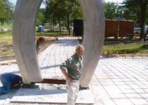 At the start of the construction of the first AIDS Monument in the nation, Zaldivar is photographed as a 5 ton steel arch is placed at the monument.