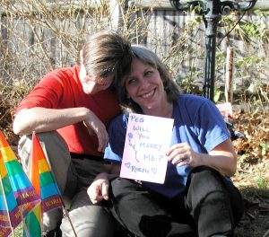 Robyn Ochs proposes to Peg Preble in their backyard weeks after the Massachusetts Supreme Judicial Court ruled in favor of marriage equality, 2013. (Photo Credit: Kristine Grimes)