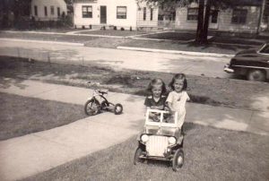 Susan and her sister and their first car, circa 1952.