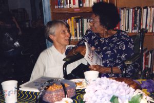 Suzanne Pharr with Daisy Bates, who led the integration of Central High School. Daisy holds a copy of Suzanne’s book, Homophobia: A Weapon of Sexism.