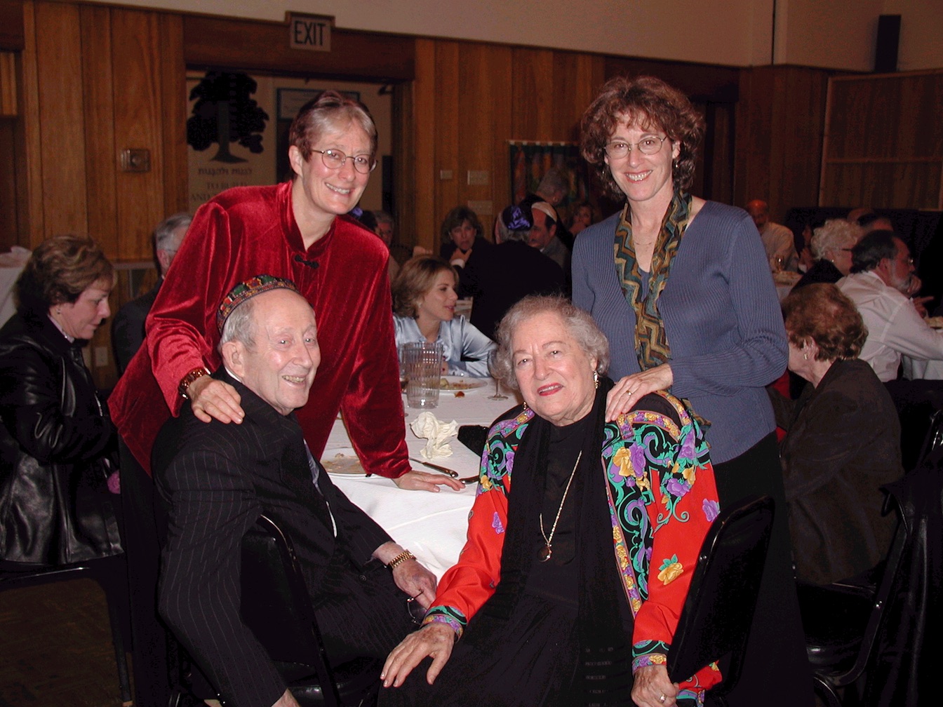 Terry and her sister, Nancy Shapiro, with their parents, Macy and Suzanne Baum, at Nancy’s daughter Rose’s batmitzvah, Berkeley, CA, 2002. Photo credit: Janaki Wilkinson. Photo courtesy of Terry Baum.