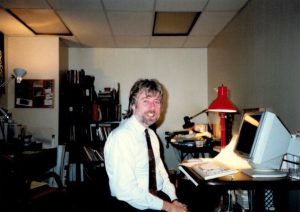 Tom Mosmiller sitting at his desk as a San Francisco General Hospital Executive Staff, 1987, San Francisco, CA. Tom remarks: “I organized HIV/AIDS programs in the 1980s such as the Transfusion Risk Notification project to contact more than 10,000 transfusion recipients.”