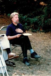 Tom Mosmiller sitting on a chair in the Oakland Hills for a wedding, 1991, Oakland, CA. Tom read an 1855 model pro-feminist wedding contract, 