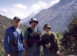 This is a photo of Gary, Craig, and Lori taken at Namchee Bazaar, Nepal, 11,291 ft above sea level in 1995.  We had a 17 day trek in Nepal that took us to Kalapathar, approximately 18,519 ft. above sea level and 1000 feet above the first base camp for climbers to Everest.  The three peaks in the background are Ama Deblang, Lhotse, and Everest.