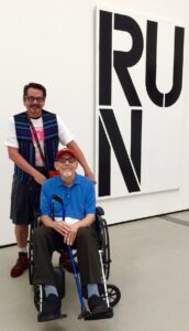 Jolino and David in front of a sign that reads “Run”, the Broad, Los Angeles, CA, 2019.