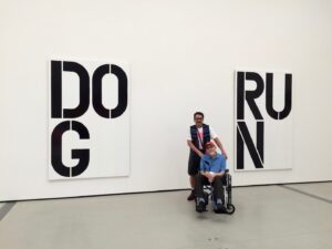 Jolino and David in front of signs that read “Dog” and “Run”, the Broad, Los Angeles, CA, 2019.