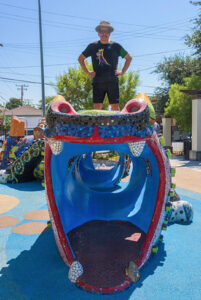 Jolino atop his finished mosaic dragon at Benito Juárez Park, Maywood, CA, 2013.
