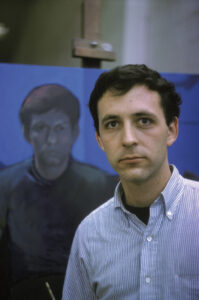 David in front of his painting, a self-portrait in blues, at Carnegie Mellon University, Pittsburgh, PA, 1963.