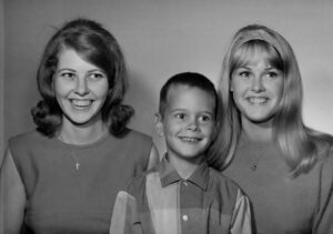L-R: Carol Freeman (sister), Chris Freeman, and Robin Freeman (sister) posing for a department store family photo, 1966. Photo courtesy of Chris Freeman.