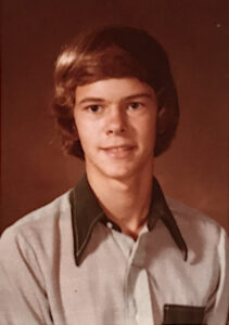 The last school portrait of Chris (age 16) at Juanita High School, fall 1977. He shares, “My mom got that shirt at the thrift store she worked for in Aberdeen since we had just moved to Juanita from Aberdeen a few months before. There was an identical one in red that I would trade off. I cut my own hair as well. Within a few weeks, I’d start smoking pot and within a year, I’d be living on my own.” Photo courtesy of Chris Freeman.