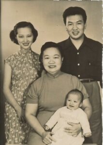 A family portrait with Terry’s grandmother holding him and his parents in the background.