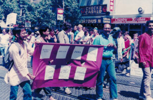 Arvind holding a purple banner that defines South Asia (i.e. Bangladesh, Bhutan, India, Nepal, Pakistan, Sri Lanka, and Tibet) at the Pride parade, San Francisco, CA, 1986.