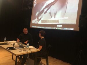 Mehmet chatting with choreographer Tuğçe Tuna about his life and professional work as part of the Contemporary Dance Talks series at Bomontiada in Istanbul, Turkey. A paused video with Mehmet’s portrait is in the background. Photo courtesy of Mehmet Sander.