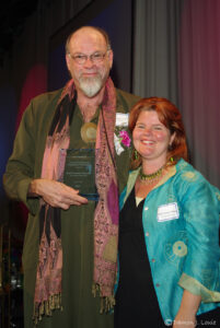 David holding his KQED/Kaiser Permanente Local Hero Award for his intersex community volunteer activism, which was presented to him by Maya Scott-Chung (at right) at the KQED Public Broadcasting Center in San Francisco, CA, June 11, 2008.